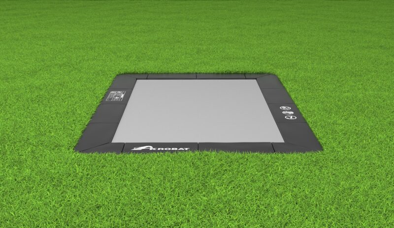 A tablet placed on lush grass, set against a backdrop of rich greenery, creating a peaceful and natural atmosphere.