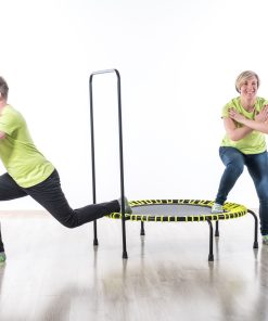 A lively scene of two people jumping on a trampoline within a spacious, white room, emphasizing movement and excitement.