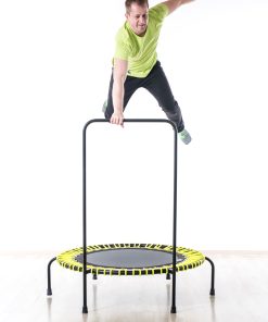 A man performs a dynamic jump on a trampoline, capturing a moment of excitement and physical activity.