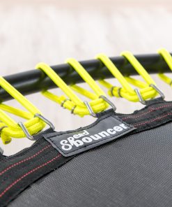 Close-up image of a trampoline with striking yellow and black straps, illustrating the unique design and robust features.