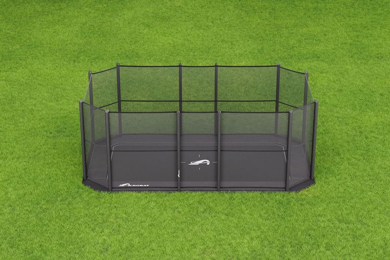 17ft x 10ft Akrobat Primus Flat PLUS In-Ground Trampoline - Special Edition (Black Pad with Black Mat) 2 A compact black cage placed on lush green grass, highlighting a tranquil and natural environment.