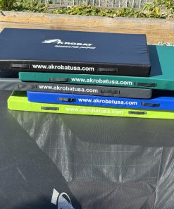 A trampoline featuring four distinct colored pads, showcasing a vibrant and playful design for recreational use.