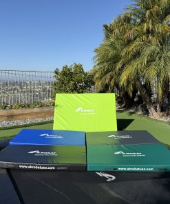 A trampoline featuring four distinct colored squares arranged on its surface, showcasing vibrant hues for playful activity.