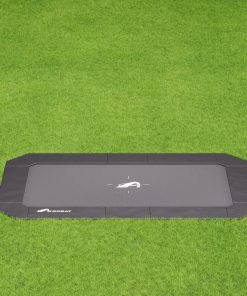 A black rectangular tray placed on a vibrant green field, contrasting the dark surface with the lush grass beneath.