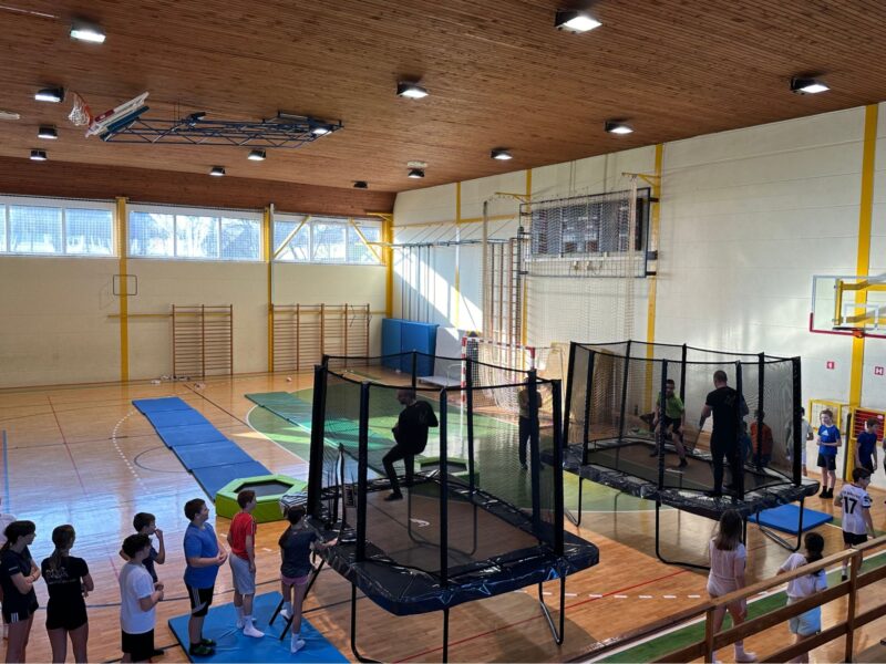 Benefits of Trampolines for ADHD: Improve Focus, Energy & Mood 6 kids in school jumping on trampoline